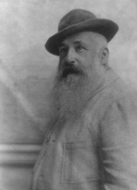 Perfil de un hombre con una barba prominente y sombrero, sobre un fondo descolorido, que desprende un aire vintage.